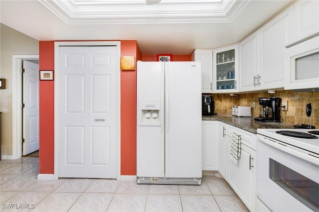 2912 SW 1st Ter, Cape Coral, FL 33991 - kitchen with white appliances, a tray ceiling, white cabinetry, decorative backsplash, and glass insert cabinets