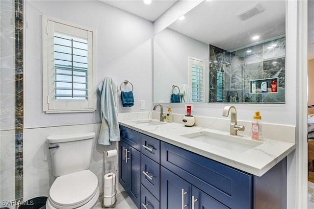 2912 SW 1st Ter, Cape Coral, FL 33991 - full bathroom featuring toilet, double vanity, tiled shower, and recessed lighting