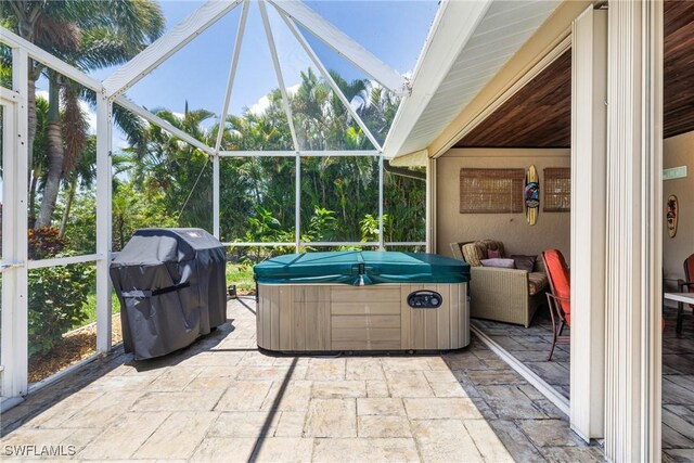 2912 SW 1st Ter, Cape Coral, FL 33991 - view of patio / terrace with a hot tub, glass enclosure, and grilling area