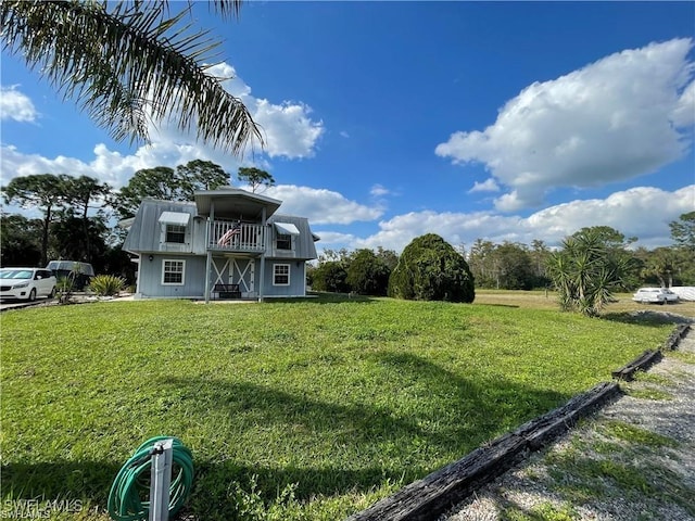 19790 Burgundy Farms Rd, Estero, FL 33928 - view of front of house featuring a balcony and a front lawn