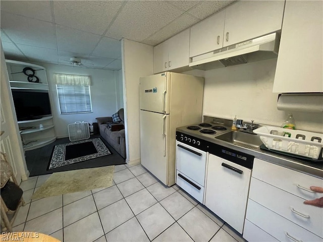 19790 Burgundy Farms Rd, Estero, FL 33928 - kitchen featuring under cabinet range hood, a drop ceiling, a sink, light tile patterned floors, and white cabinetry