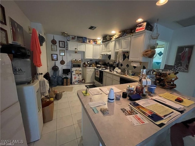 19790 Burgundy Farms Rd, Estero, FL 33928 - kitchen with stainless steel microwave, light tile patterned floors, range with electric stovetop, white cabinetry, and recessed lighting