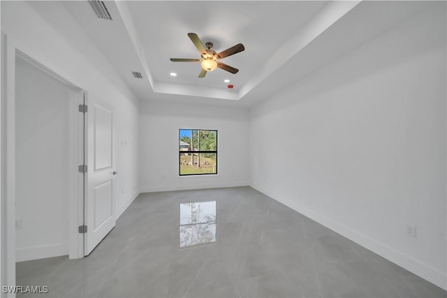 1904 E 11th St, Lehigh Acres, FL 33936 - unfurnished bedroom with a tray ceiling, recessed lighting, baseboards, and a ceiling fan