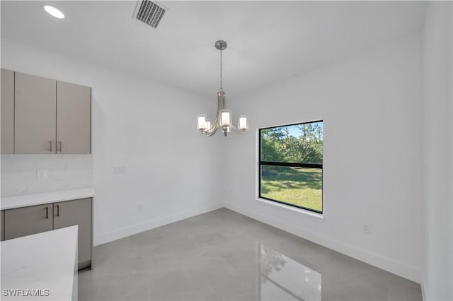 1904 E 11th St, Lehigh Acres, FL 33936 - unfurnished dining area with a chandelier, baseboards, and recessed lighting