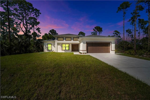 1904 E 11th St, Lehigh Acres, FL 33936 - prairie-style house featuring stucco siding, a garage, concrete driveway, and a lawn