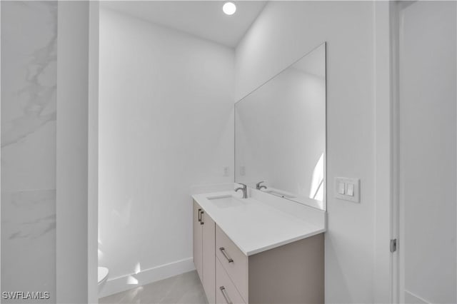 1904 E 11th St, Lehigh Acres, FL 33936 - bathroom with vanity, toilet, and baseboards