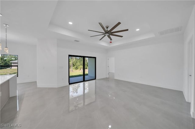 1904 E 11th St, Lehigh Acres, FL 33936 - unfurnished room featuring a tray ceiling, a ceiling fan, healthy amount of natural light, recessed lighting, and baseboards