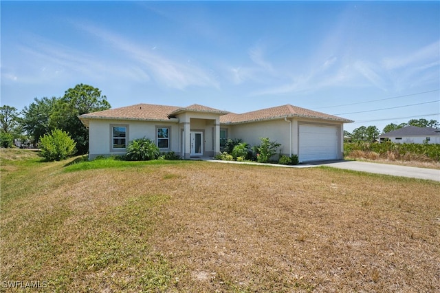 4174 58th Ave NE, Naples, FL 34120 - view of front of property featuring driveway, stucco siding, a front lawn, and a garage