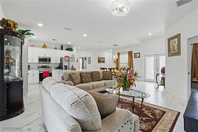 4174 58th Ave NE, Naples, FL 34120 - living area with light marble finish floors and recessed lighting