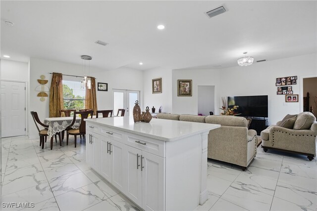4174 58th Ave NE, Naples, FL 34120 - kitchen with light marble finish floors, recessed lighting, white cabinetry, light countertops, and open floor plan