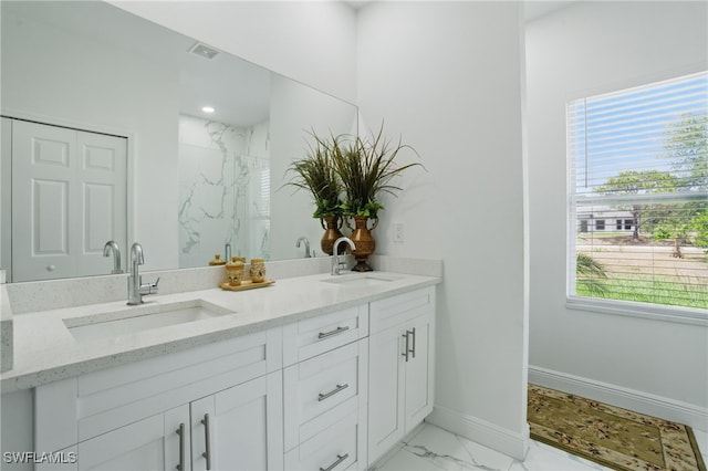 4174 58th Ave NE, Naples, FL 34120 - bathroom with plenty of natural light, marble look tiles, baseboards, and double vanity