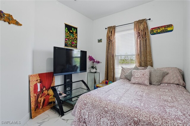 4174 58th Ave NE, Naples, FL 34120 - bedroom with marble look tile flooring and baseboards