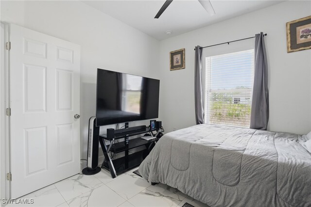 4174 58th Ave NE, Naples, FL 34120 - bedroom featuring light marble finish floors and a ceiling fan