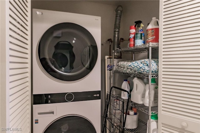 1878 Tarpon Bay Dr S Unit 102, Naples, FL 34119 - clothes washing area with stacked washing machine and dryer