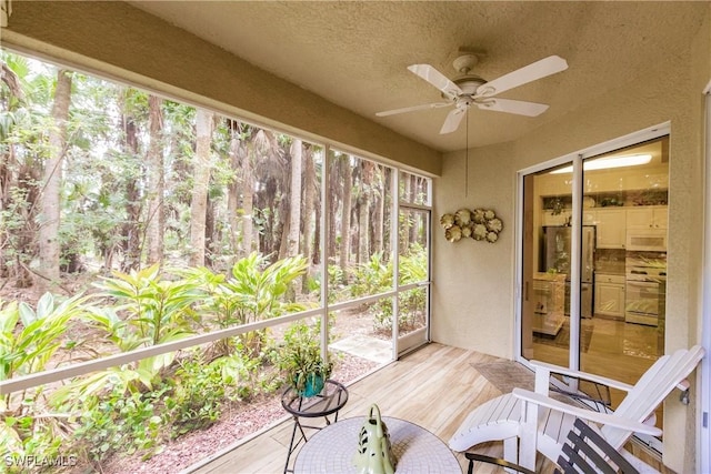 1878 Tarpon Bay Dr S Unit 102, Naples, FL 34119 - sunroom featuring ceiling fan, wood finished floors, and a textured ceiling