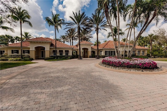 1878 Tarpon Bay Dr S Unit 102, Naples, FL 34119 - view of building exterior featuring curved driveway