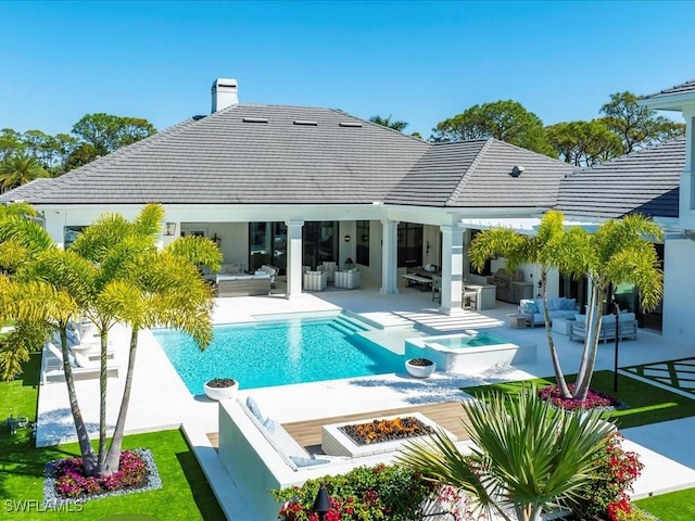 186 N St, Naples, FL 34108 - rear view of house with an outdoor living space with a fire pit, a patio area, and a tile roof