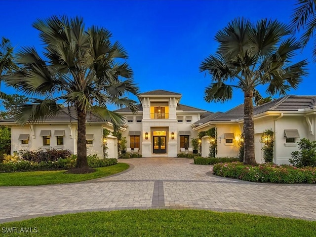 186 N St, Naples, FL 34108 - view of front of house with french doors, curved driveway, and stucco siding