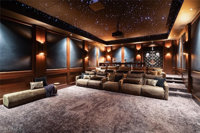 186 N St, Naples, FL 34108 - carpeted home theater with a raised ceiling and a decorative wall