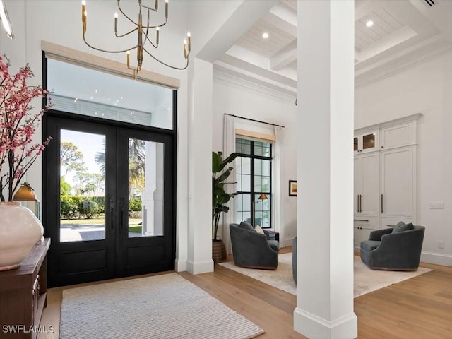 186 N St, Naples, FL 34108 - foyer featuring french doors, a high ceiling, light wood-type flooring, beamed ceiling, and coffered ceiling