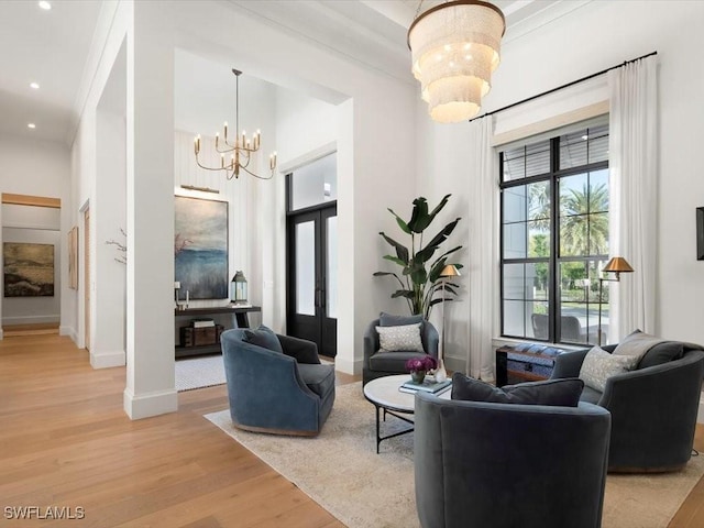 186 N St, Naples, FL 34108 - living area with a chandelier, light wood-style flooring, baseboards, recessed lighting, and a towering ceiling