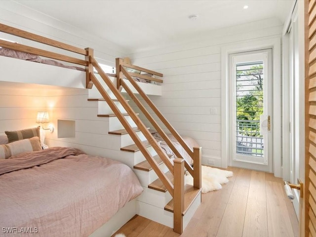 186 N St, Naples, FL 34108 - bedroom with access to exterior, light wood-style flooring, and wooden walls