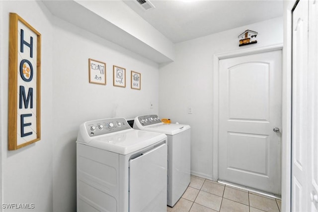 2210 SW 14th Ave, Cape Coral, FL 33991 - washroom with separate washer and dryer and light tile patterned floors