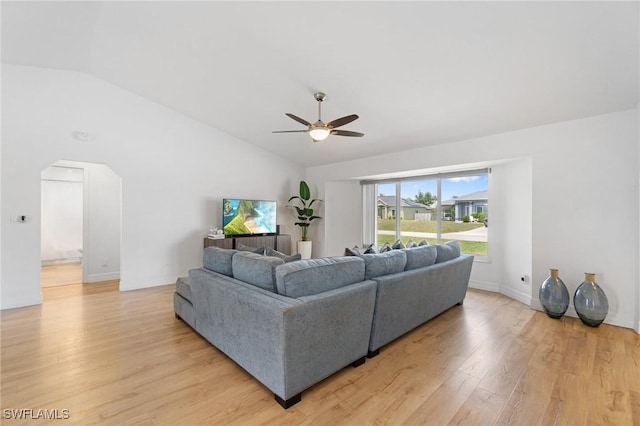 2210 SW 14th Ave, Cape Coral, FL 33991 - living area featuring vaulted ceiling, a ceiling fan, light wood finished floors, arched walkways, and baseboards