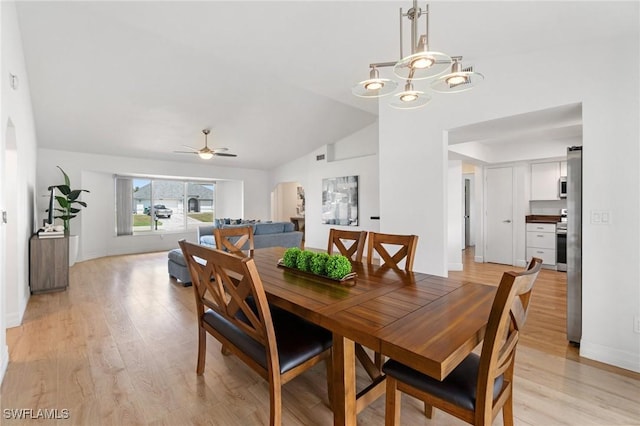 2210 SW 14th Ave, Cape Coral, FL 33991 - dining area with vaulted ceiling, light wood-style floors, a chandelier, ceiling fan, and baseboards