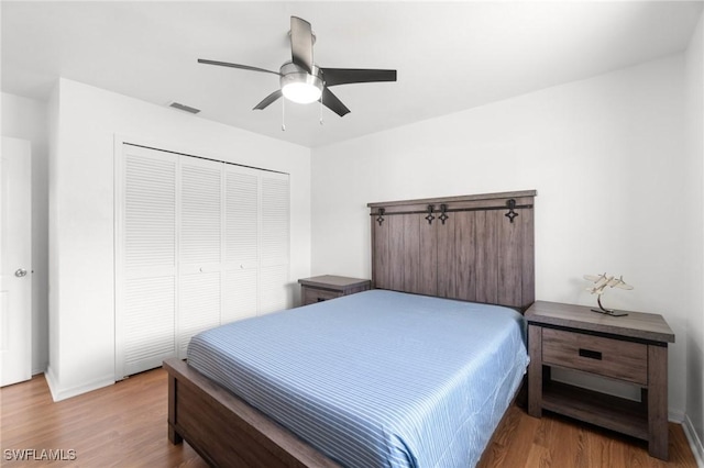 2210 SW 14th Ave, Cape Coral, FL 33991 - bedroom with wood finished floors, a closet, and a ceiling fan