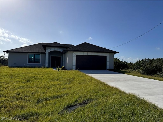 view of front of house featuring a front yard, an attached garage, stucco siding, and concrete driveway