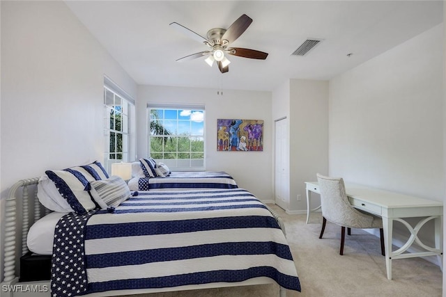 bedroom with light colored carpet, baseboards, and ceiling fan