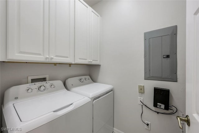 laundry area with electric panel, separate washer and dryer, cabinet space, and baseboards