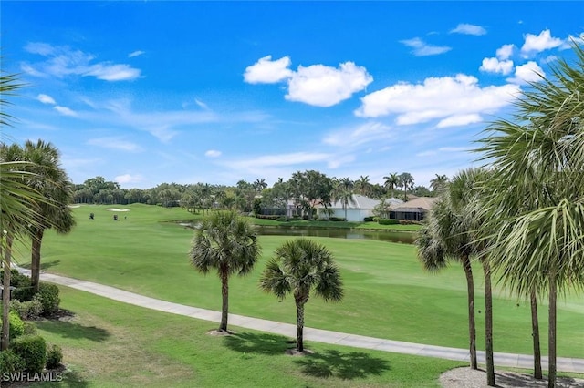 surrounding community featuring golf course view, a lawn, and a water view
