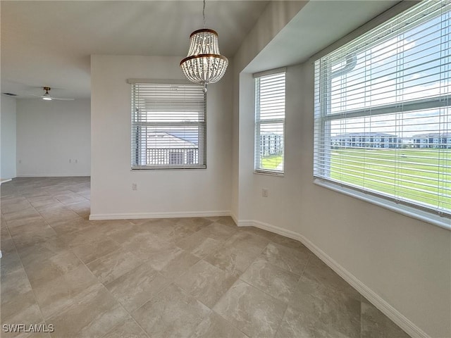5583 Double Eagle Cir Unit 4141, Ave Maria, FL 34142 - empty room with a chandelier, baseboards, ceiling fan, and light tile patterned floors