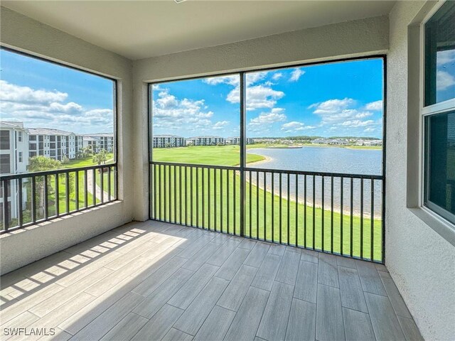 5583 Double Eagle Cir Unit 4141, Ave Maria, FL 34142 - unfurnished sunroom featuring a water view