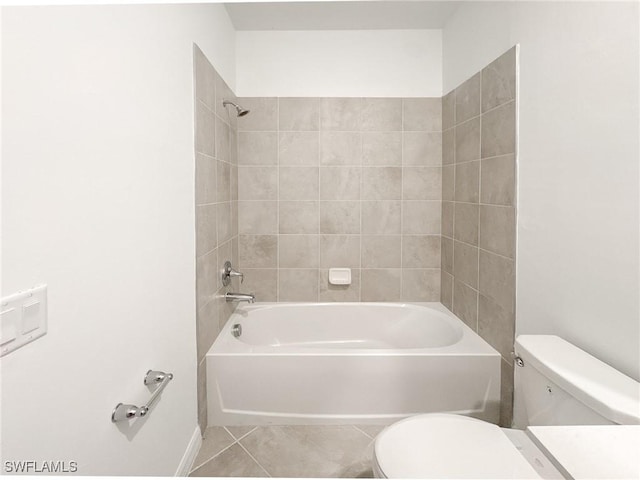 5583 Double Eagle Cir Unit 4141, Ave Maria, FL 34142 - bathroom with toilet, tile patterned flooring, washtub / shower combination, and baseboards