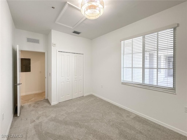 5583 Double Eagle Cir Unit 4141, Ave Maria, FL 34142 - unfurnished bedroom featuring multiple windows, carpet flooring, a closet, and baseboards
