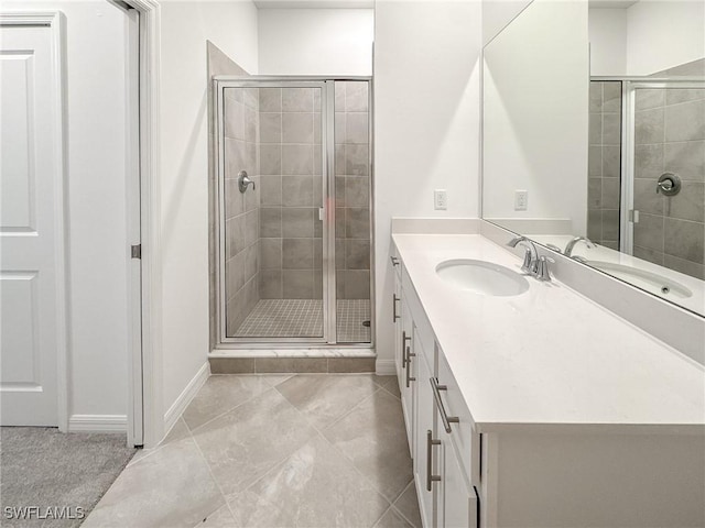 5583 Double Eagle Cir Unit 4141, Ave Maria, FL 34142 - bathroom featuring vanity, a stall shower, baseboards, and tile patterned flooring