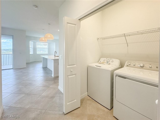 5583 Double Eagle Cir Unit 4141, Ave Maria, FL 34142 - laundry area with independent washer and dryer, light tile patterned floors, and baseboards
