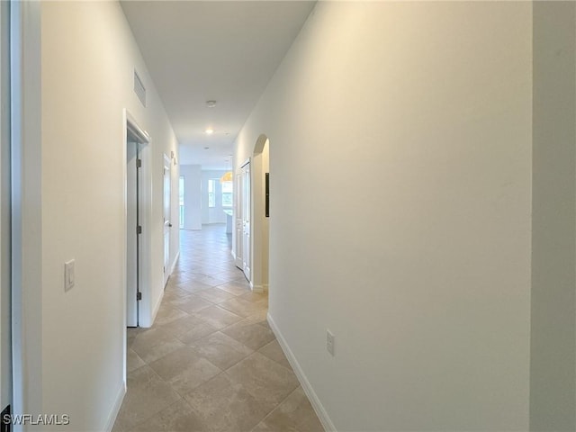 5583 Double Eagle Cir Unit 4141, Ave Maria, FL 34142 - hallway with baseboards and arched walkways