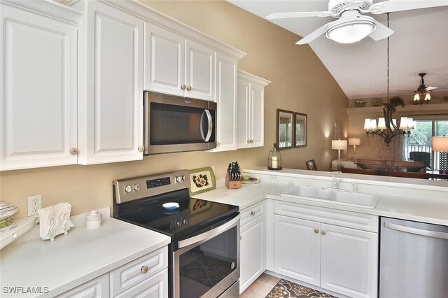 3880 Sawgrass Way Unit 2423, Naples, FL 34112 - kitchen featuring appliances with stainless steel finishes, vaulted ceiling, ceiling fan, a sink, and a chandelier