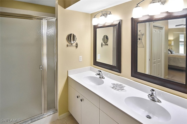 3880 Sawgrass Way Unit 2423, Naples, FL 34112 - ensuite bathroom featuring a shower stall, double vanity, tile patterned floors, and baseboards