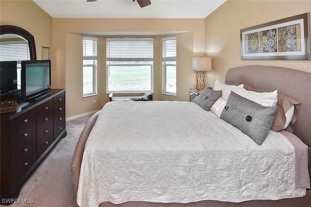3880 Sawgrass Way Unit 2423, Naples, FL 34112 - bedroom with carpet floors, multiple windows, baseboards, and a ceiling fan