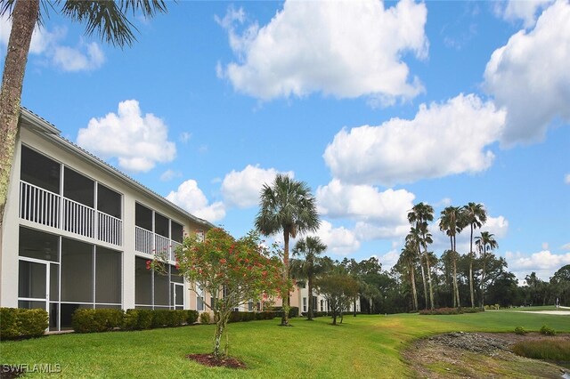 3880 Sawgrass Way Unit 2423, Naples, FL 34112 - view of home's community with a lawn and golf course view