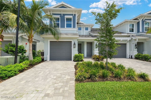 2647 Seychelles Cir Unit 2203, Naples, FL 34112 - view of front of home featuring decorative driveway, stucco siding, and a garage