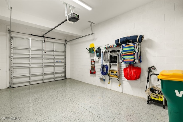 2647 Seychelles Cir Unit 2203, Naples, FL 34112 - garage featuring a garage door opener and concrete block wall