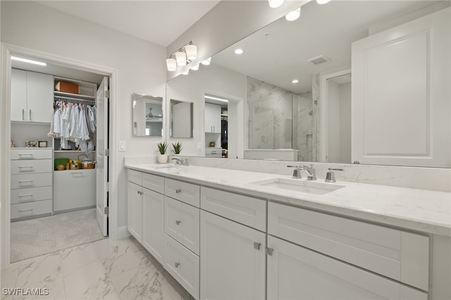 2647 Seychelles Cir Unit 2203, Naples, FL 34112 - bathroom featuring a spacious closet, a marble finish shower, double vanity, recessed lighting, and marble finish floors