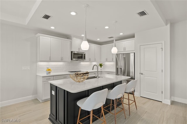 2647 Seychelles Cir Unit 2203, Naples, FL 34112 - kitchen featuring stainless steel appliances, baseboards, backsplash, light countertops, and white cabinetry