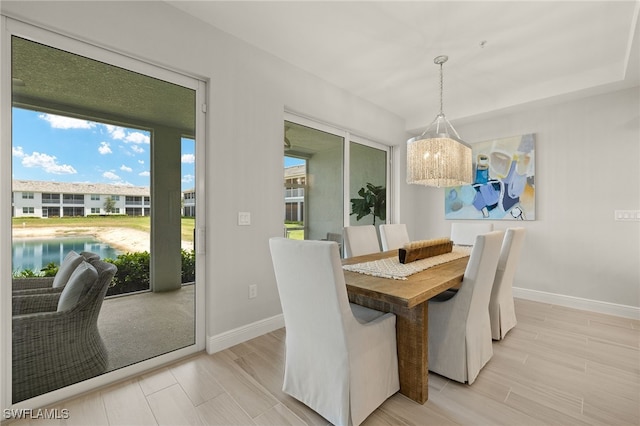 2647 Seychelles Cir Unit 2203, Naples, FL 34112 - dining room with baseboards, light wood-style flooring, and a chandelier